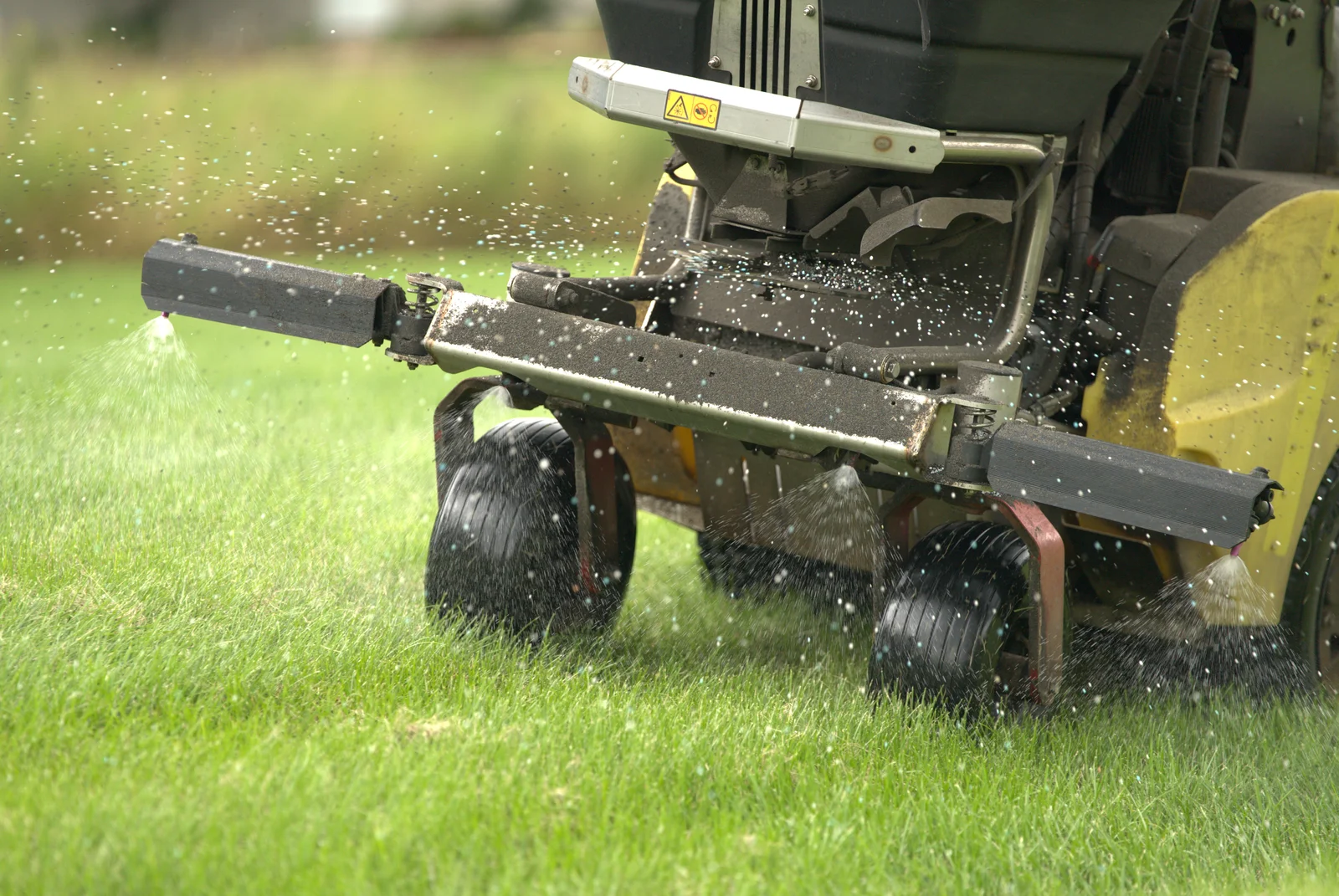 Green Acres lawn aeration service in progress with professional aerator equipment on healthy green grass